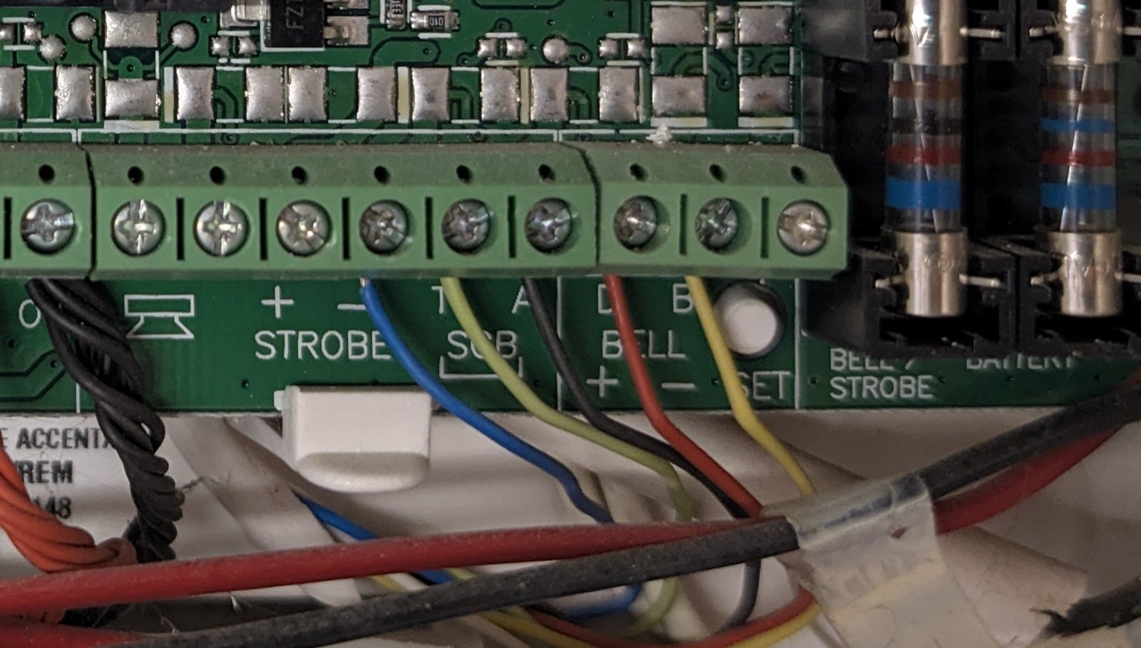 Honeywell Accenta panel terminals labeled T, A, D, and B beside the strobe and bell outputs